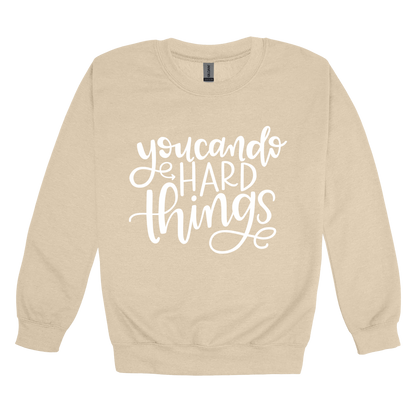 You Can Do Hard Things design on a Sand adult crewneck sweatshirt, front view.