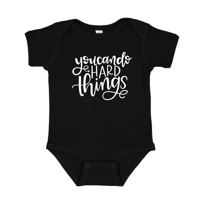 You Can Do Hard Things design on a Black infant onesie, front view.