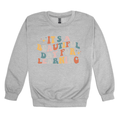 It's a Beautiful Day for Learning design on a Sport Gray adult crewneck sweatshirt, front view.