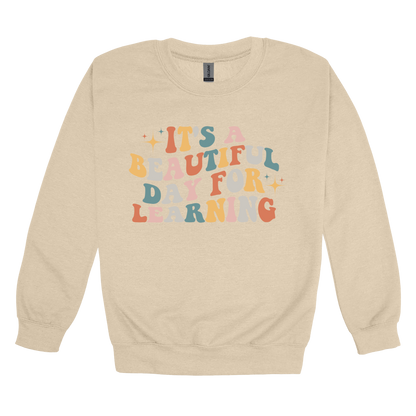 It's a Beautiful Day for Learning design on a Sand adult crewneck sweatshirt, front view.