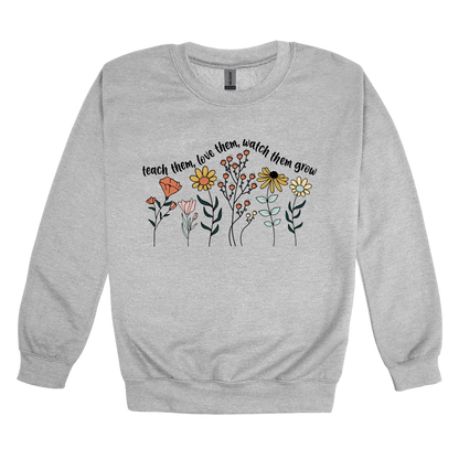 Teach Them, Love Them, Let Them Grow design on a Sport Gray adult crewneck sweatshirt, front view.