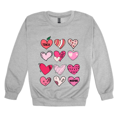 Teach Love Inspire Hearts teacher design on Sport Gray adult Crewneck, front view.