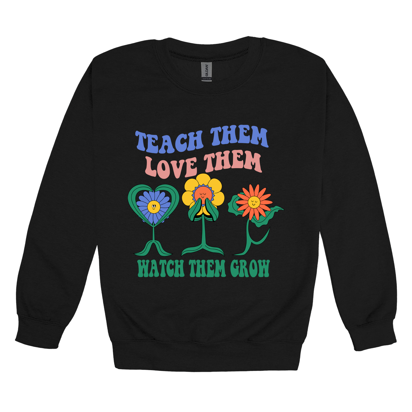 Teach Them Love Them teacher design on Black adult Crewneck, front view.