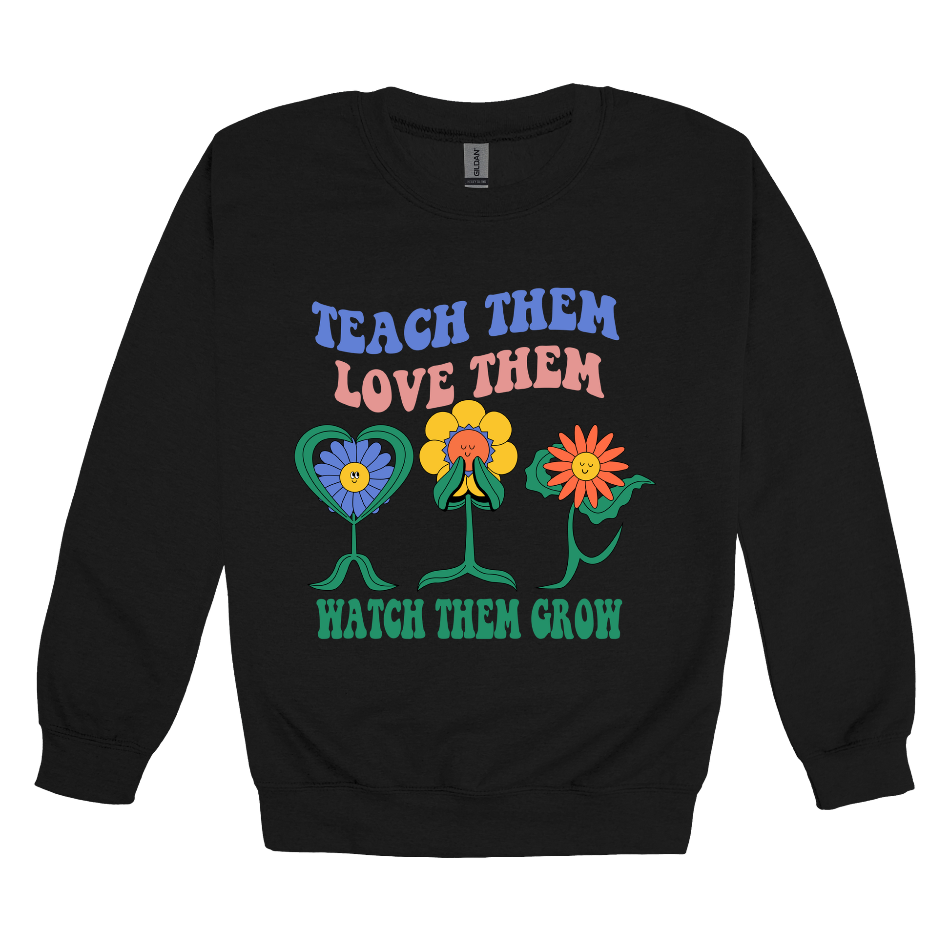 Teach Them Love Them teacher design on Black adult Crewneck, front view.