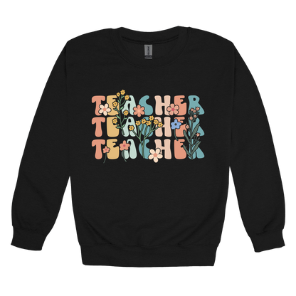 Teacher floral design on Black adult Crewneck, front view.
