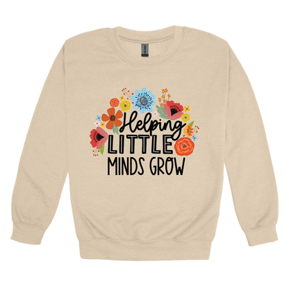Helping Little Minds Grow Apparel design on adult crewneck in tan, front view.