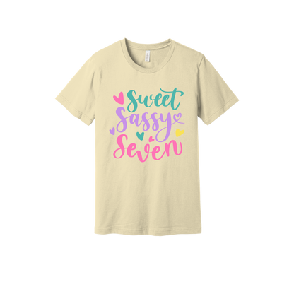 Sweet and Sassy Seven Apparel design on generic tee presentation in tan, front view.