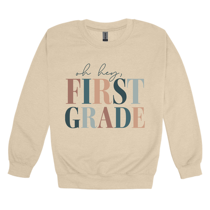 Oh Hey First Grade design shown on Sand adult Gildan crewneck sweatshirt.