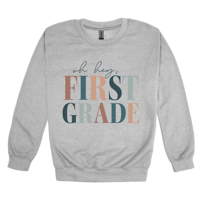 Oh Hey First Grade design shown on Sport Gray adult Gildan crewneck sweatshirt.