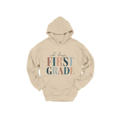 Oh Hey First Grade design shown on Sand adult Gildan hoodie.