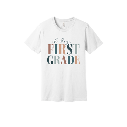 Oh Hey First Grade design shown on White adult Bella+Canvas 3001 T-shirt.