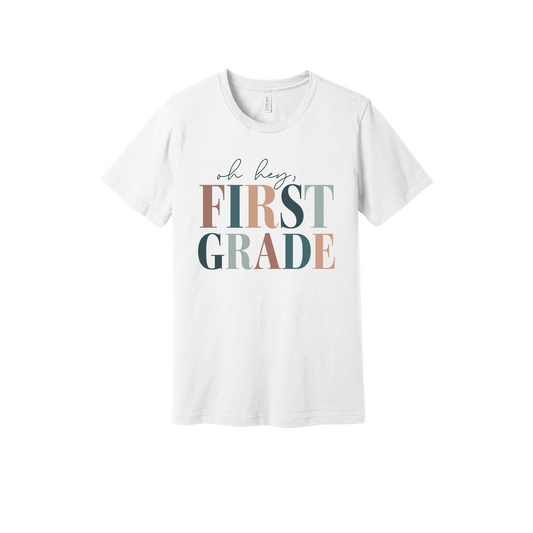 Oh Hey First Grade design shown on White adult Bella+Canvas 3001 T-shirt.