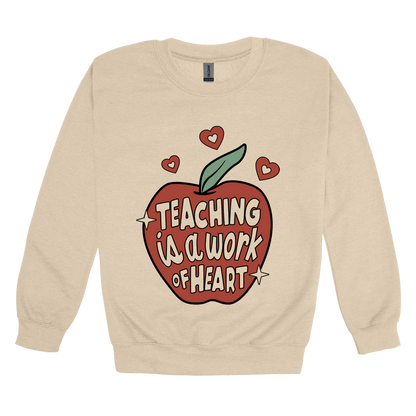 Teaching Is a Work of Heart design shown on Sand adult Gildan crewneck sweatshirt.